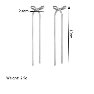 Silver bow tassel earrings detail with 10cm drop length and 2.4cm width dimensions