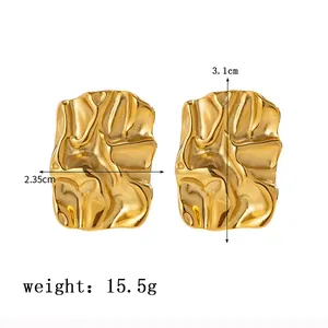 Detail view of 18K gold plated stainless steel earrings with irregular wrinkled texture