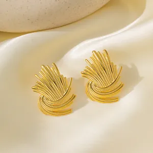 Elegant gold lava fold earrings in radiating fan design on soft beige satin background