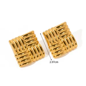 Detail view showing textured gold woven square stud earrings measuring 2.97cm in diameter