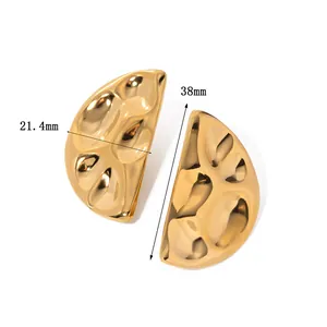 Macro detail of 38mm gold plated irregular crumpled texture earrings with glossy finish