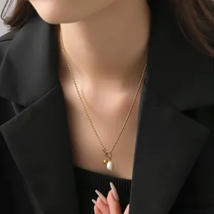 Elegant gold bead necklace with oval pearl pendant and OT clasp on model