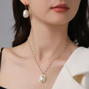 Elegant gold titanium steel necklace and earring set featuring oval white pearls for women