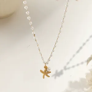 Detailed view of large oval pearl necklace with a textured gold starfish pendant charm