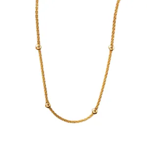 Elegant gold-plated stainless steel star necklace with polished bead accents and twisted chain