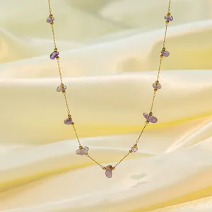 Irregular purple stone necklace with gold stainless steel chain on cream silk background