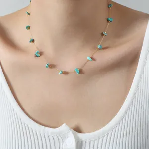 Elegant gold chain necklace with natural turquoise stone beads on female model