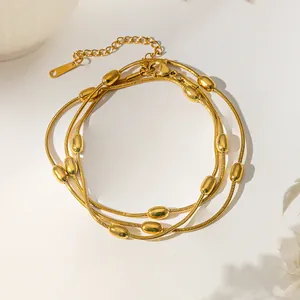 Layered gold snake chain necklace with smooth oval beads in a minimalist luxury style