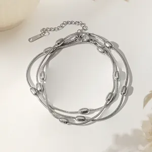Detail of silver layered snake chain necklace with polished beads and lobster clasp closure