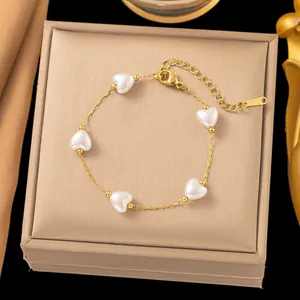 Elegant gold choker necklace featuring five irregular white baroque pearls in a chic style