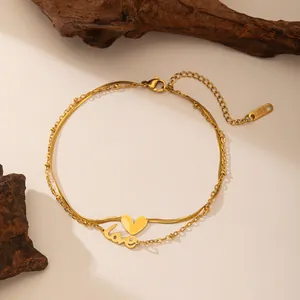 Tobillera de doble capa en acero dorado con colgantes de corazón y palabra love