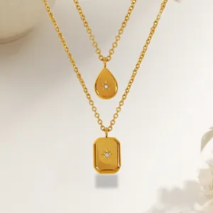 Minimalist gold necklace set with teardrop and rectangular pendants featuring starburst detail
