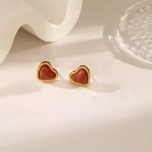 Elegant gold-trimmed heart stud earrings with vintage deep red resin inlays