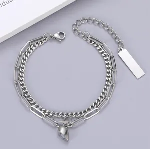 Close-up of double-layer silver couple bracelet with half-heart magnetic pendant