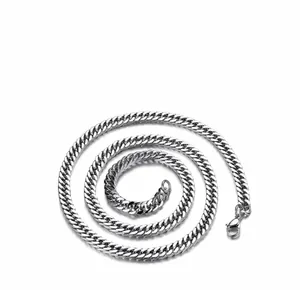Close-up of polished stainless steel Cuban link chain necklace with a lobster clasp