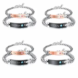 Detailed close-up of matching couple bracelets with engraved tags and small crystals