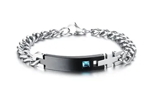 Macro shot of Cuban chain bracelet with black identity plate and blue square zircon