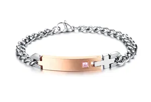 Detail of titanium steel cuban chain bracelet with pink zircon and cross element