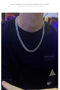 Close-up of thick silver Cuban link necklace on a model wearing black streetwear
