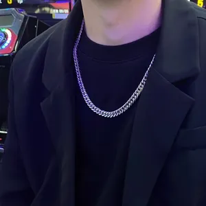Polished silver cuban link chain necklace in stainless steel worn by male model