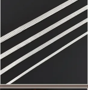 Detail of four silver herringbone chains in various widths with a polished metallic finish