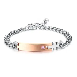 Silver steel chain bracelet with rose gold bar, pink crystal, and hollow cross pendant