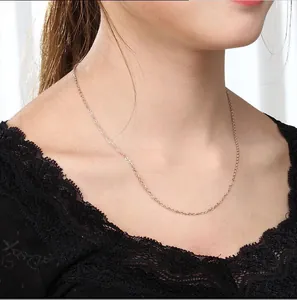 Close-up of minimalist rose gold stainless steel O-chain necklace on a model