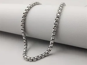 Macro shot of polished silver box chain necklace with high gloss metal texture