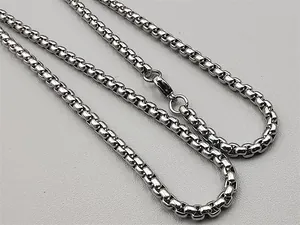 Close-up of silver steel box chain necklace featuring a secure lobster clasp closure