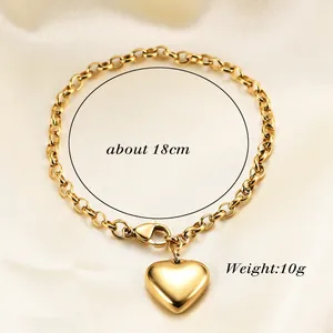 Detail of golden heart bracelet with thick chain and lobster clasp on silk background