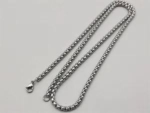 Close-up of a polished stainless steel box chain necklace with a secure lobster clasp