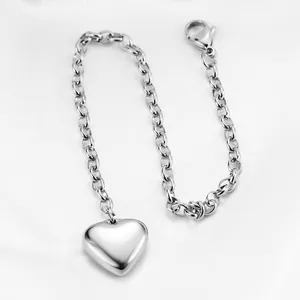 Polished silver heart pendant bracelet on white silk with adjustable cable chain and lobster clasp