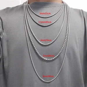 Detail view of titanium steel pearl chains in various widths and lengths on a model
