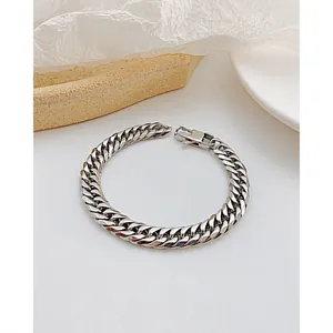 Detail of silver-toned stainless steel Cuban link bracelet with a large lobster clasp