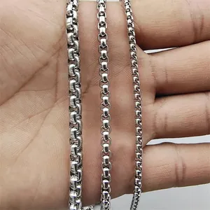 Three silver stainless steel box chains in different widths held by a hand to show scale