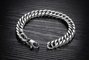 Detailed close-up of a silver cuban link chain bracelet with a secure lobster clasp