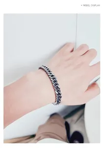 Polished silver cuban link chain bracelet shown on male wrist for a hip hop style look
