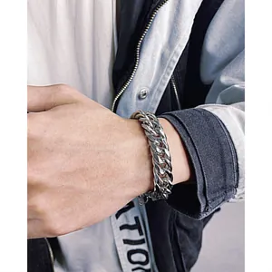 Close-up of double-layer silver Cuban chain bracelet worn on wrist for street style