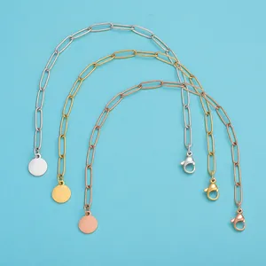 Detailed macro view of gold, silver, and rose gold stainless steel paperclip chain bracelets