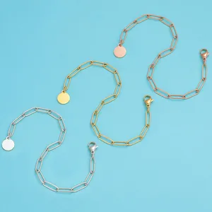 Detailed view of paperclip chains in silver, gold, and rose gold with round coin charms