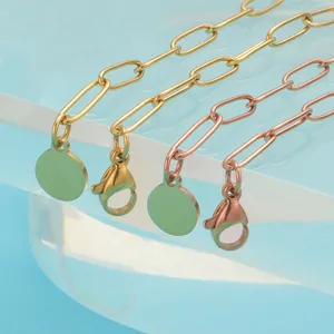 Chunky stainless steel link bracelet with round charm in gold and rose gold finishes