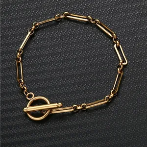 Detail of golden bamboo link necklace featuring a classic OT toggle clasp closure