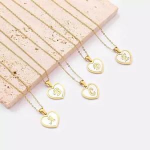 Detail view of heart-shaped 18K gold plated necklaces with shell alphabet pendants A-E