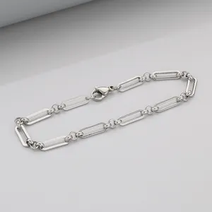 Detail view of the silver paperclip chain bracelet with a polished lobster clasp closure