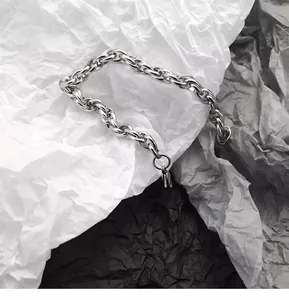 Gros plan d'un bracelet à maillons épais en acier inoxydable au style industriel moderne