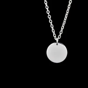 Detail of round stainless steel pendant showing polished finish and engraving options
