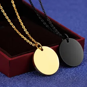 Macro shot of gold and black titanium steel circular pendants for custom engraving