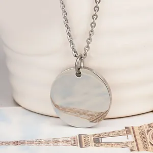 Macro shot of polished round titanium steel pendant with mirror finish on O-chain