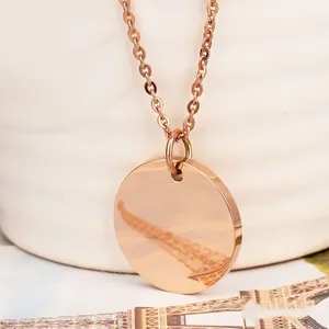 Macro shot of rose gold round pendant with reflective mirror finish and O-chain detail