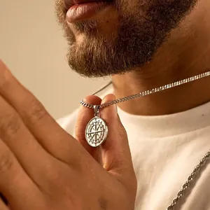 Polished silver compass pendant necklace for men with engraved direction markings